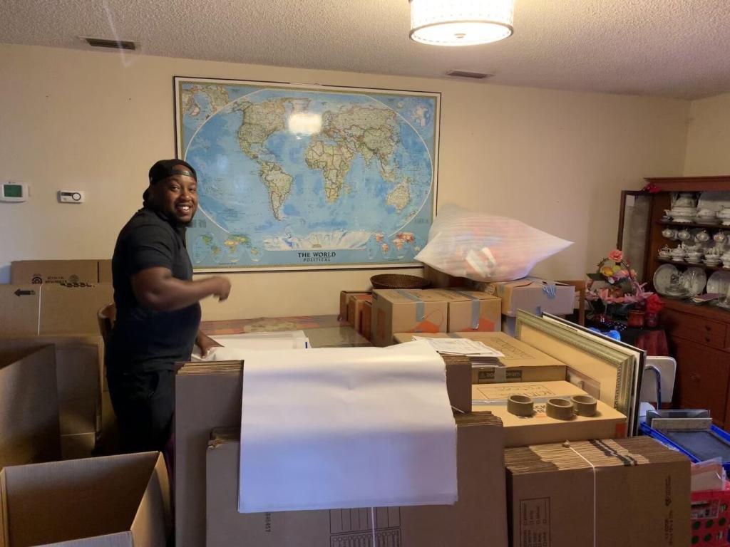 Office items packed and staged by Black Swan Moving with a map on the wall