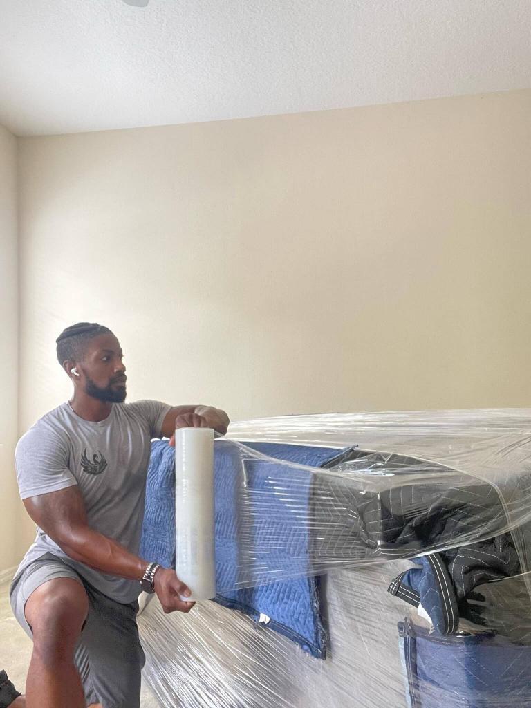 Black Swan Moving mover shrink-wrapping a padded item