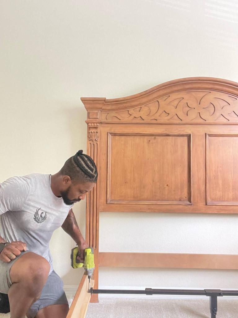 Black Swan Moving mover disassembling a bed frame before loading