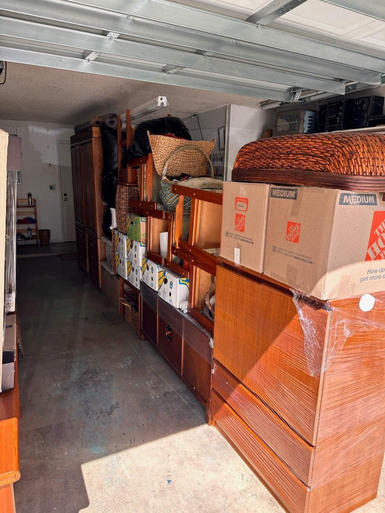 Household items staged in a garage and ready for loading by Black Swan Moving