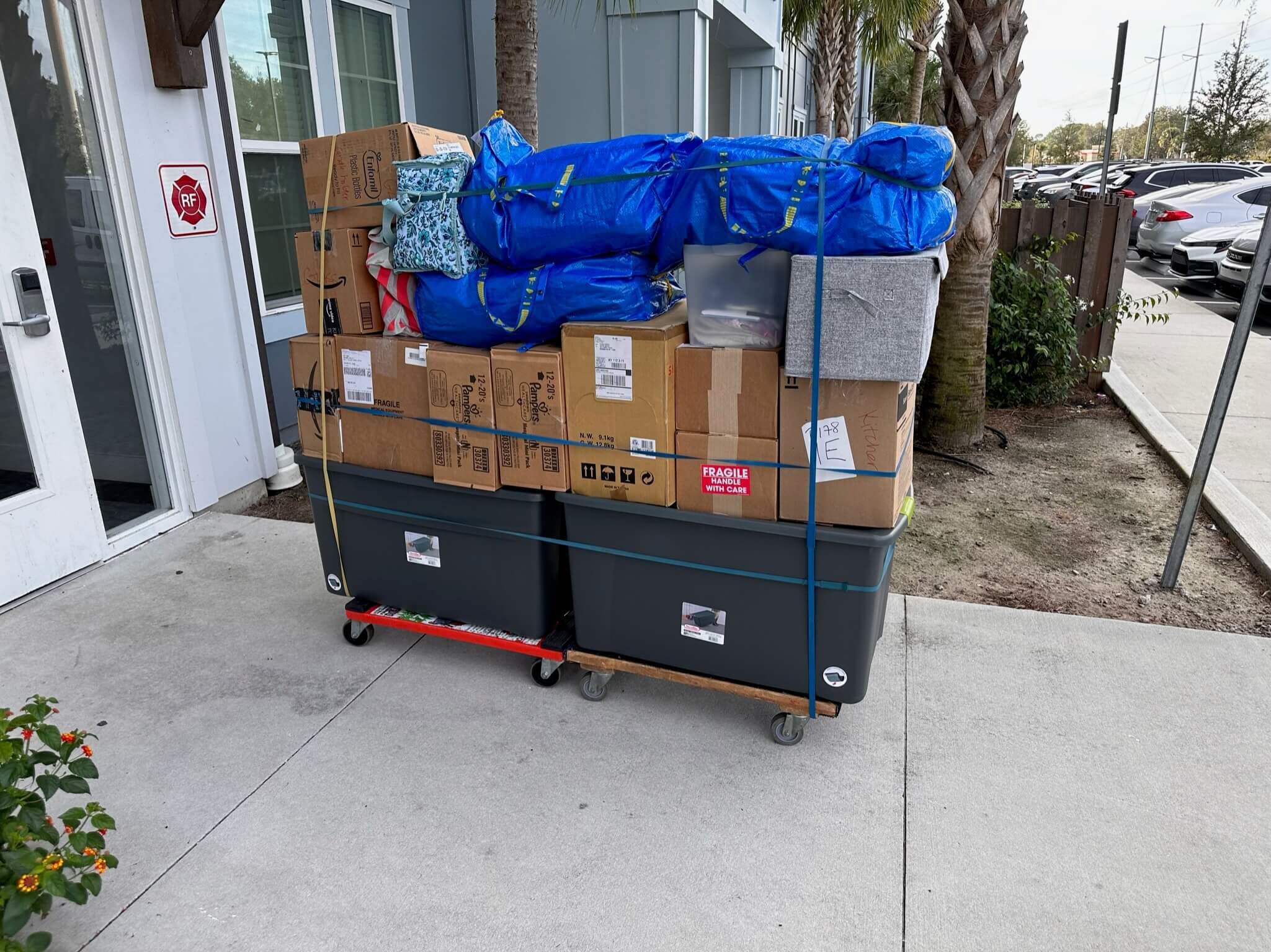 Furniture, 14 boxes, and 5 bags loaded on a four-wheel dolly.