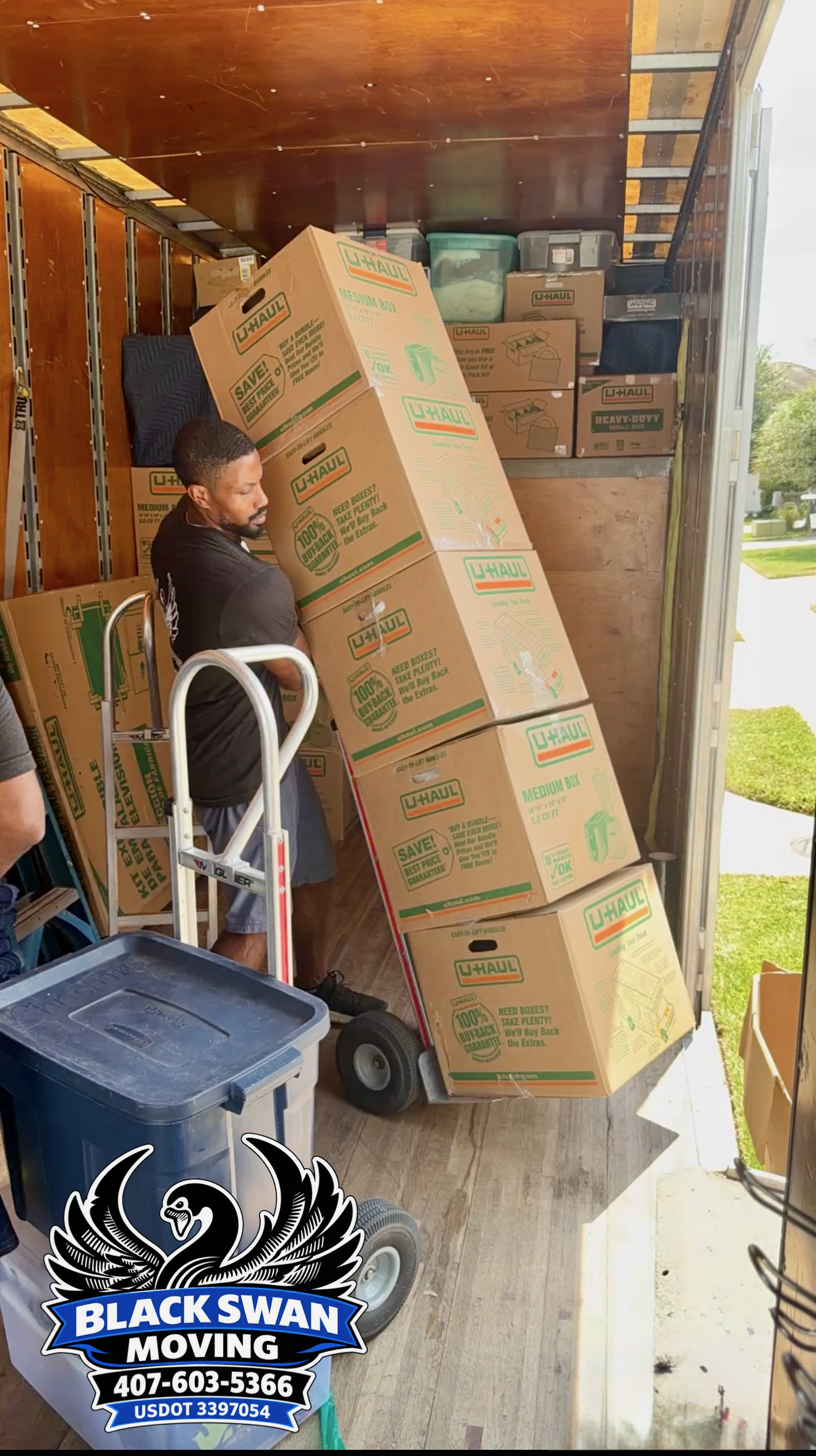Black Swan Moving professional loading packed boxes into a moving truck