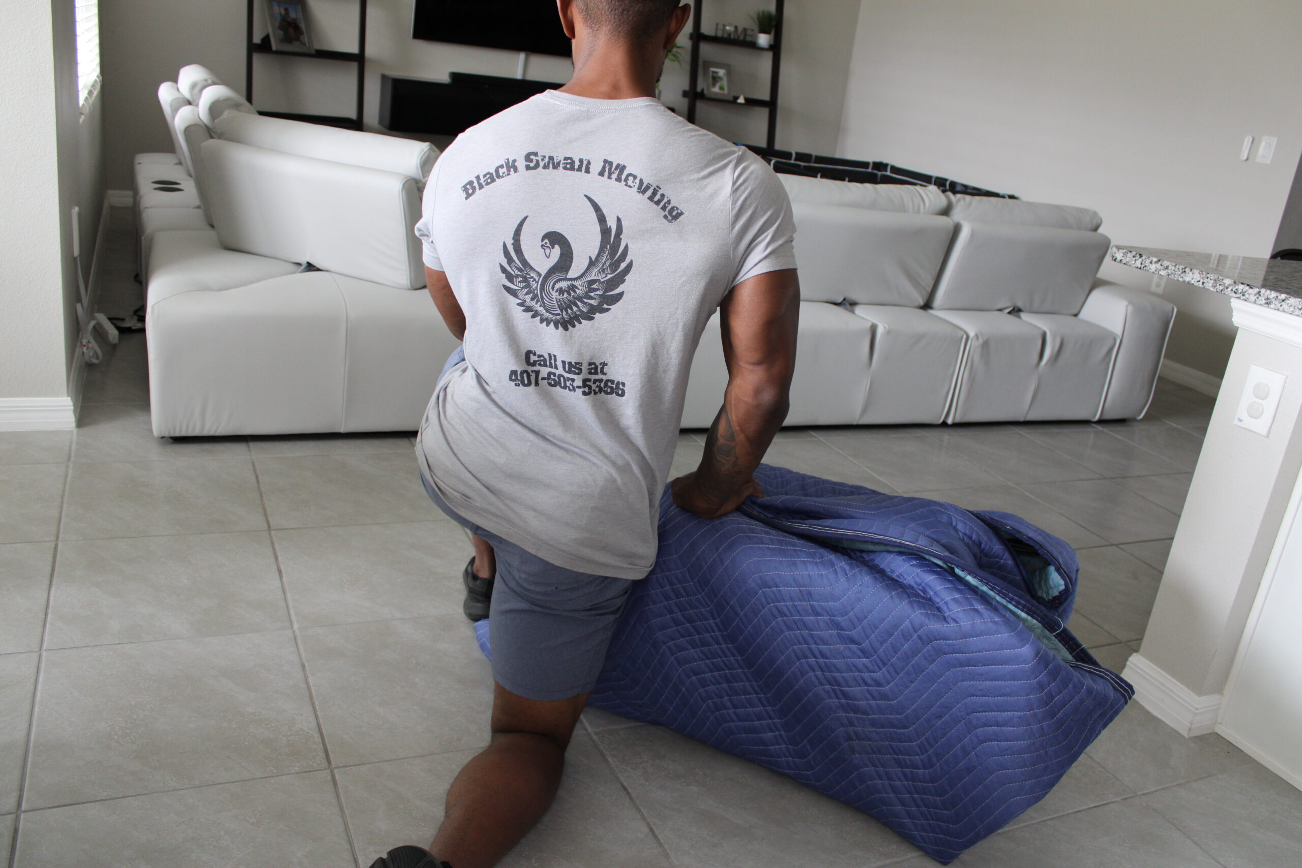 Black Swan Moving professional protecting furniture during a residential move