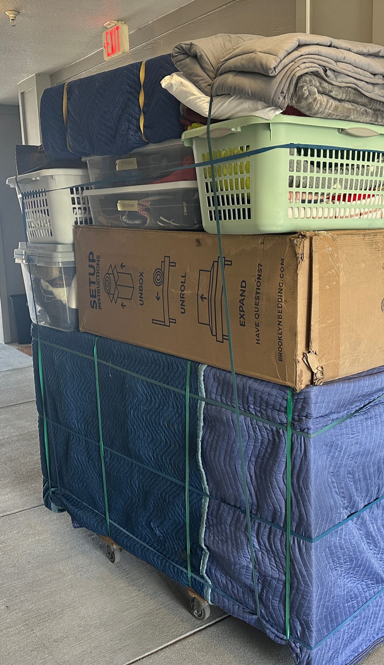 Protected household belongings prepared for a long carry at an apartment move