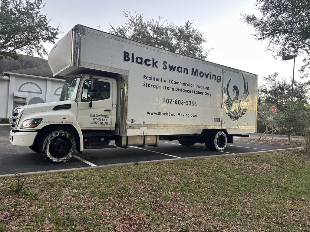 Black Swan Moving truck parked at an apartment community, ready for a Daytona Beach move