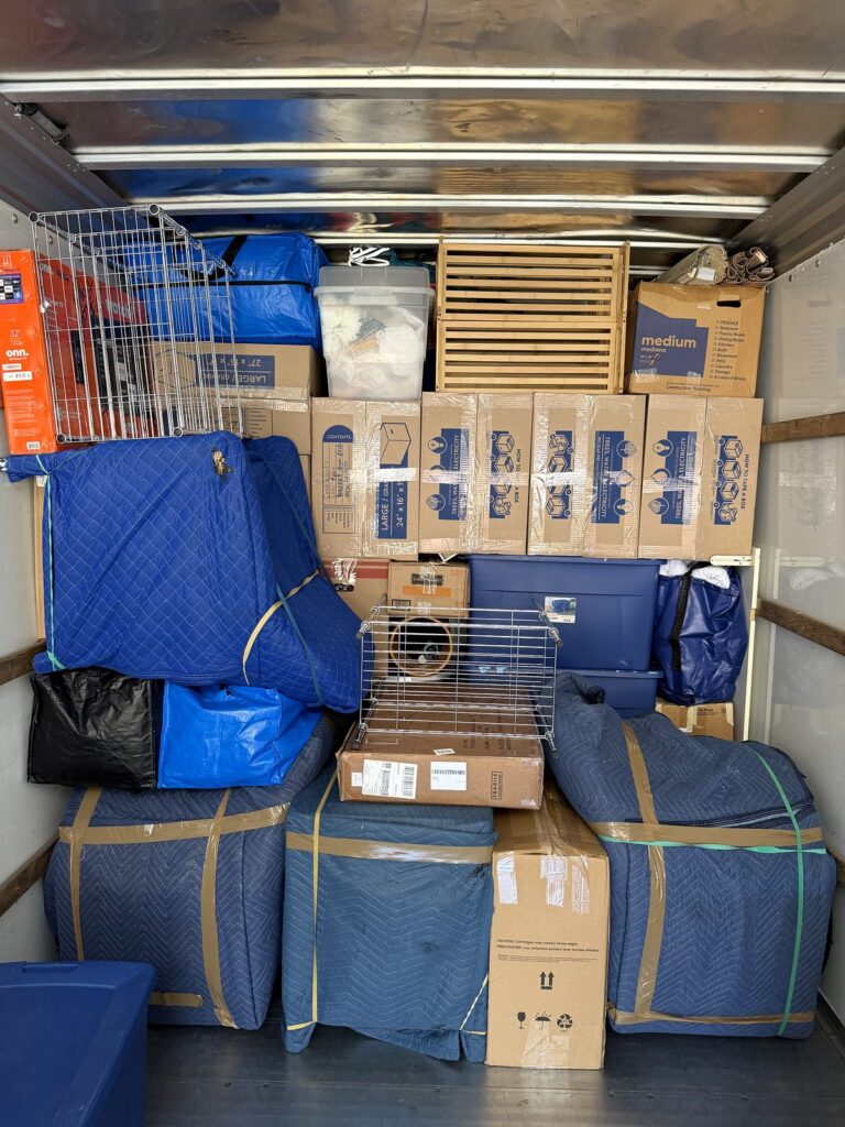 Winter Garden Movers - Black Swan Moving | 5-Star Movers in Central Florida Inside the Black Swan Moving truck: blanket-wrapped furniture, boxes, and bins loaded tight