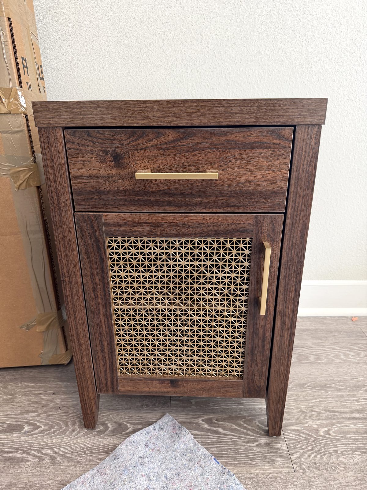 Wood nightstand on the floor before it is wrapped for the move