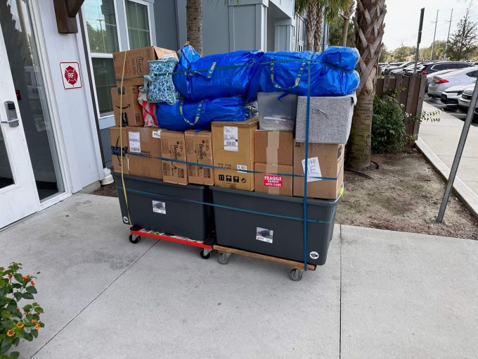 Furniture, 14 boxes, and 5 bags loaded on a four-wheel dolly.